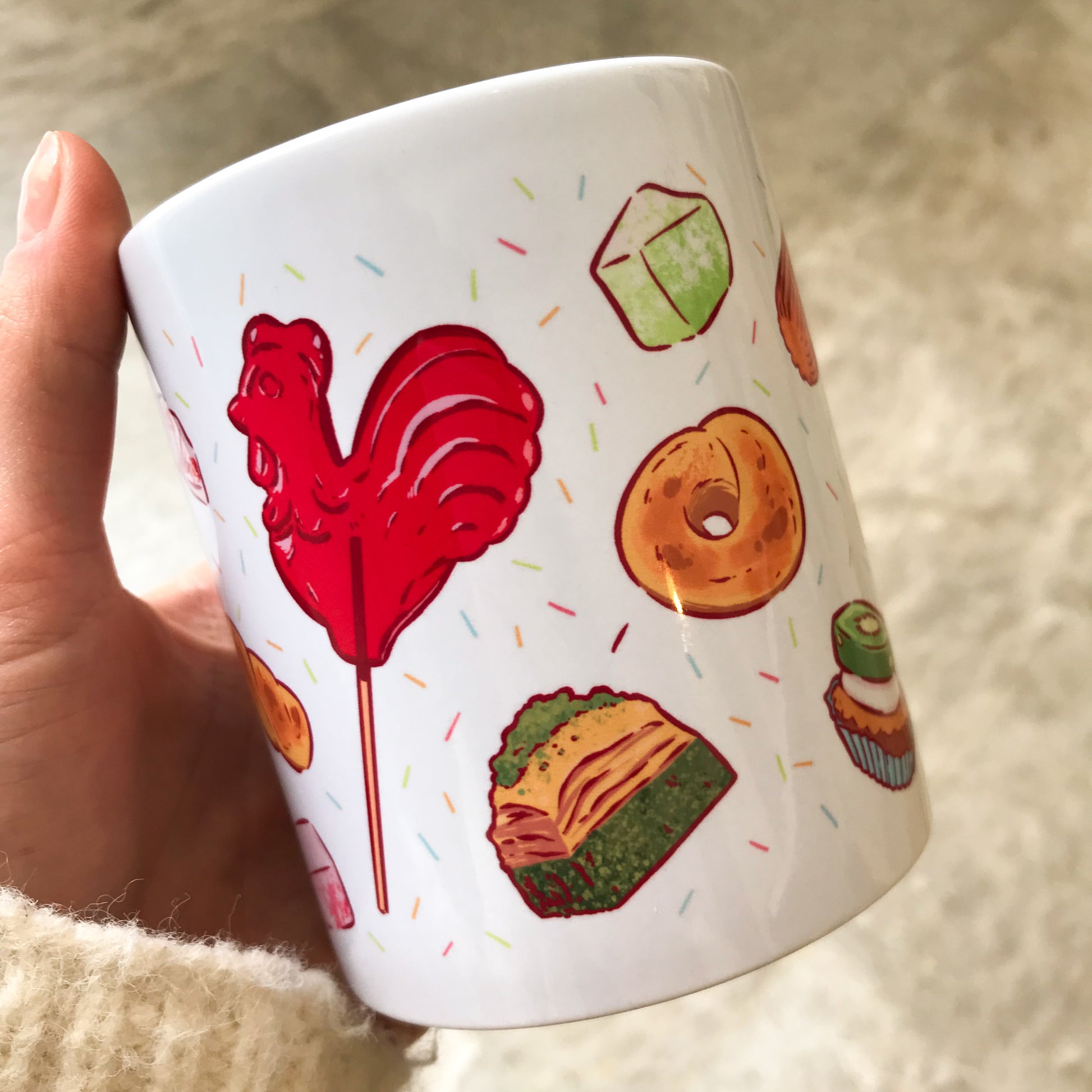 mug with greek sweets such as rooster lollipop, koulouri, baklava, apple lukum